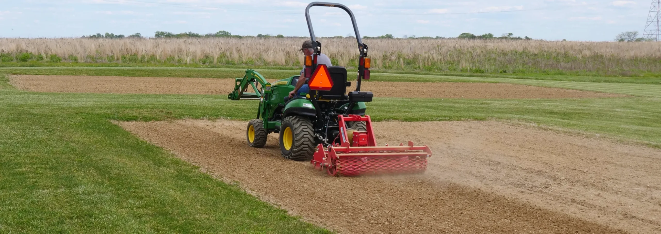 Power harrow working in field